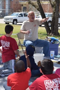 Magician Ron Boyd entertains children at a block party.